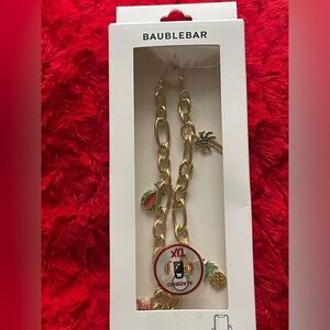 BaubleBar Gold Phone Charm Wristlet with Fun Accents